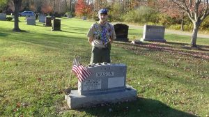 Ethan displaying his project on a grave